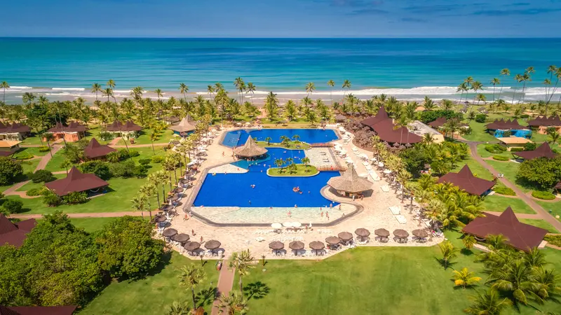 Vista aérea do Vila Galé Marés, com as piscinas, os jardins e o mar de Guarajuba